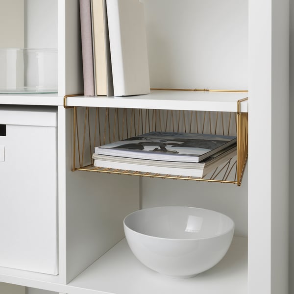 Gold-framed shelf organizes magazines, integrates with KALLAX unit.