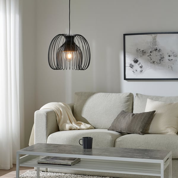 Modern living room with beige sofa, KALLFRONT lamp, gray coffee table, abstract art, minimalist decor.
