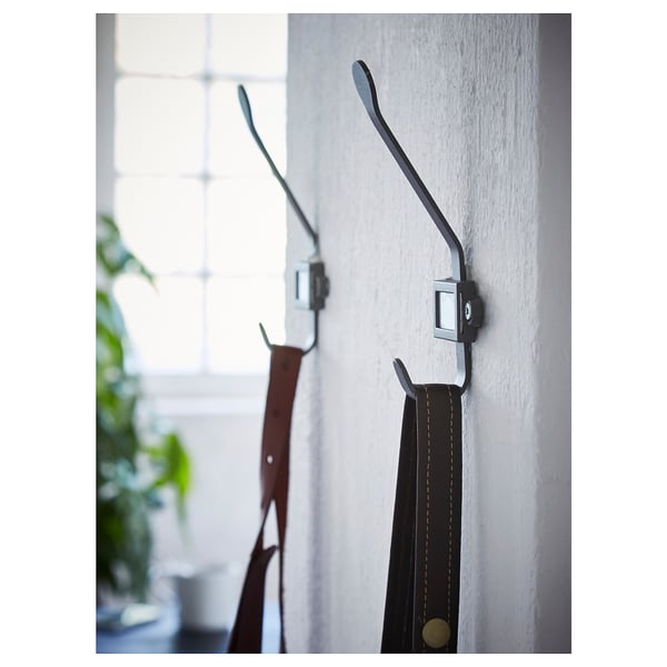 Wall hooks with labels, aluminum finish, holding red and black items.
