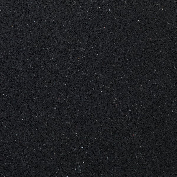 Smooth, dark quartz surface with subtle flecks, showcasing durability and stain resistance.