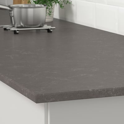 Dark grey quartz countertop with subtle veining, resistant to stains, scratches, and moisture, ideal for kitchen use.