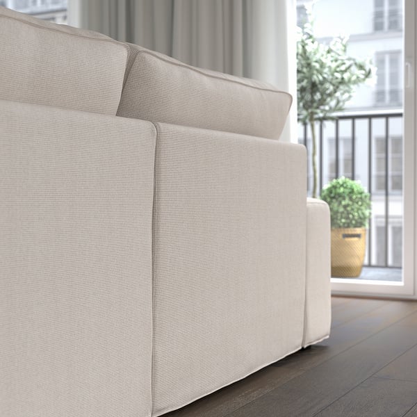 A beige KIVIK sofa with removable armrests, ensuring comfort and versatility.