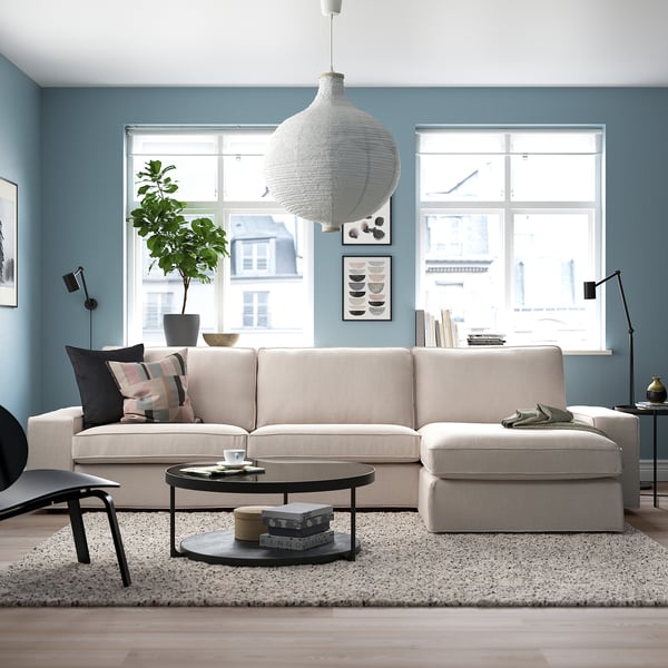 Living room with KIVIK sofa, coffee table, pendant lamp, and city views.