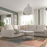 Modern living room with KIVIK sofa and metal coffee table.