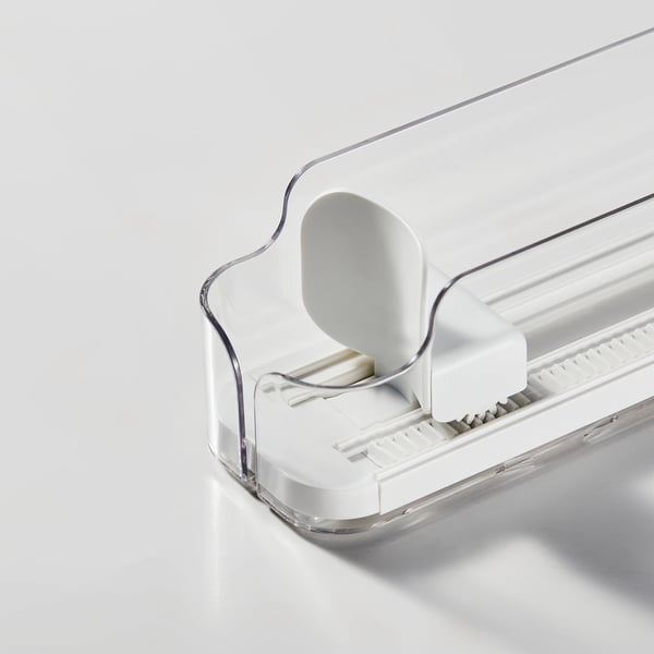 Clear plastic drink holder with adjustable sides and white mechanism, designed for organizing cans or bottles in a fridge.