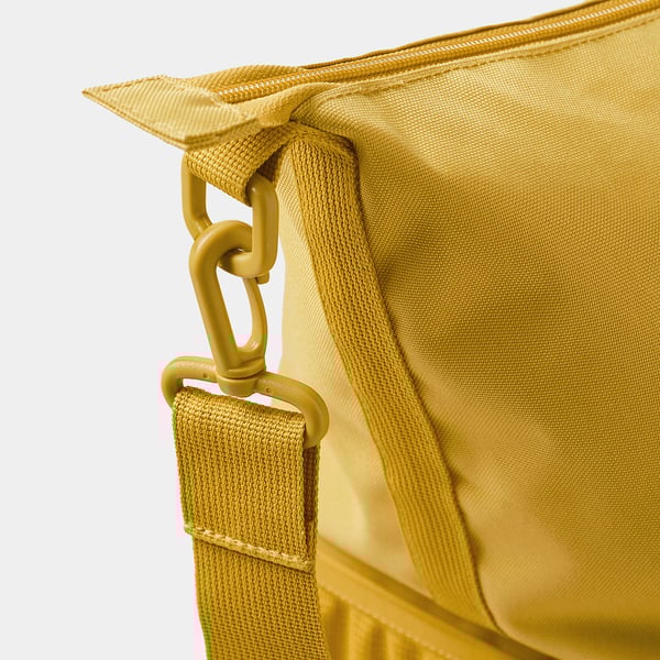 Close-up of a sturdy, tan KLOTPIL bags strap with secure plastic clips, highlighting durable fabric and design.