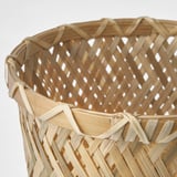 Handwoven bamboo plant basket, showcasing intricate craftsmanship.