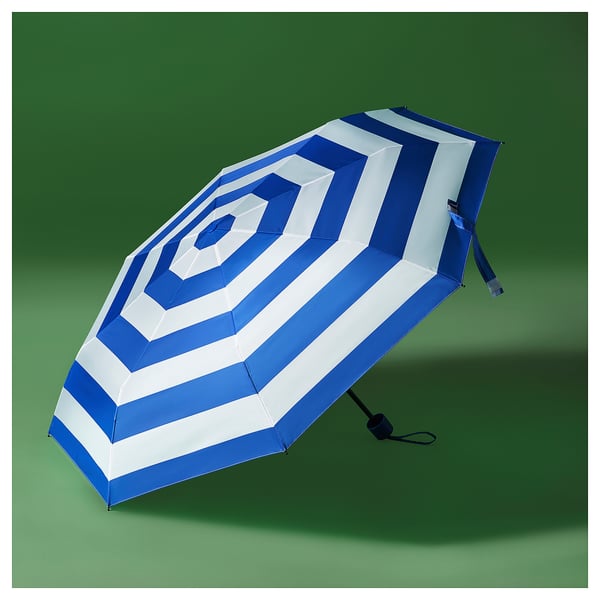 A KNALLA blue and white striped umbrella, made of polyester and steel, with a foldable design.