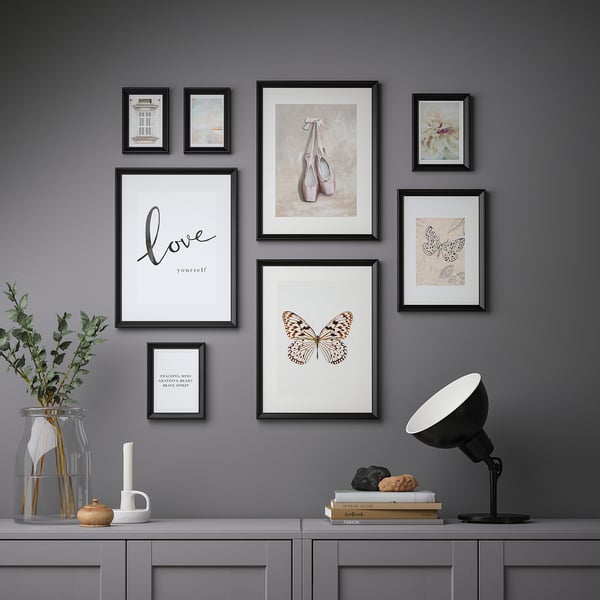 Gallery wall with 8 inspirational art prints, shown above console table.