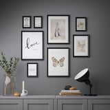 Gallery wall with 8 inspirational art prints, shown above console table.