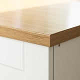 A sleek, modern kitchen countertop made of high-pressure melamine laminate, featuring a smooth, light-wood grain finish and a polished edge.