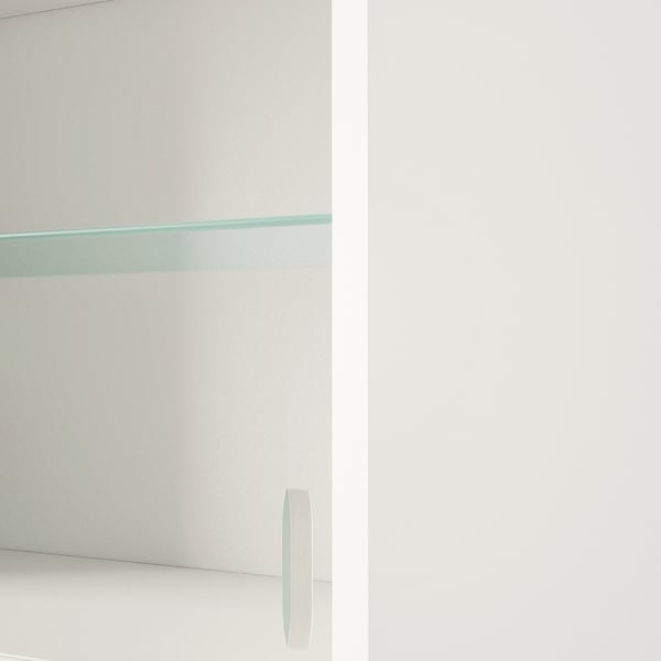 Glass-fronted wall cabinet with smooth, handle-free design for modern aesthetic.