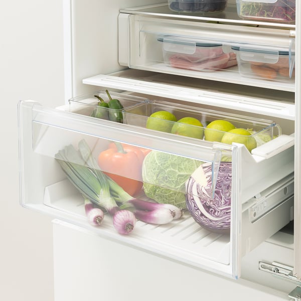 Fridge drawer with adjustable compartments holds fruits and veggies for organized, fresh storage.