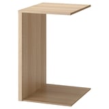 An ikea KOMPLEMENT light brown wooden wardrobe organizer in an l-shape design. It a top shelf and bottom panel for versatile storage.