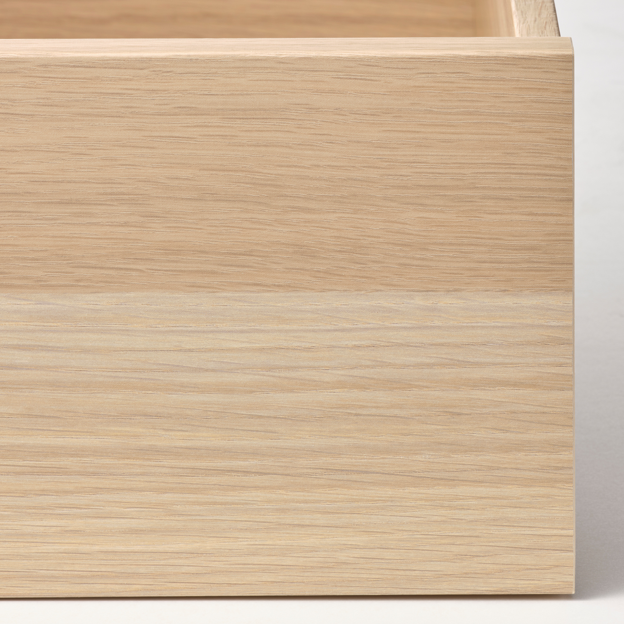 Close-up of smooth, light-colored wooden drawer, showcasing its fine grain texture and quality craftsmanship.