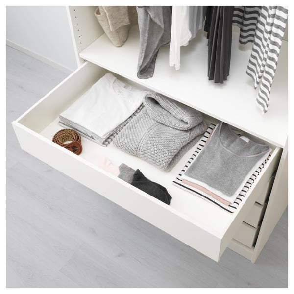 White wardrobe drawer filled with neatly folded gray clothes and small items, perfect for organizing.
