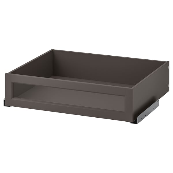 An open dark gray KOMPLEMENT drawer with a framed glass front, designed for pax wardrobes.