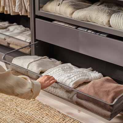 A KOMPLEMENT grey mesh storage basket, rectangular, made of steel with a powder coat finish. Its designed for organizing clothes and accessories.