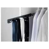 A white wardrobe with KOMPLEMENT organizers. Belts and ties hang on metal hooks.