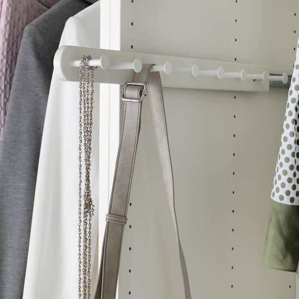 White wardrobe organizer with hooks hanging belts and jewelry.