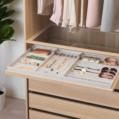 Wooden drawer with gray tray stores jewelry and accessories, soft felt lining protects items, pulls out smoothly.