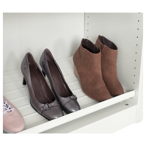 White shelf holds brown heels and boots, keeping them visible and easy to access.