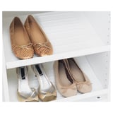 White shelf displays and organizes shoes, keeps them accessible and visible.
