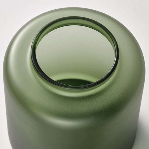 Matte green glass vase, circular top, smooth finish. Handcrafted, elegant design.