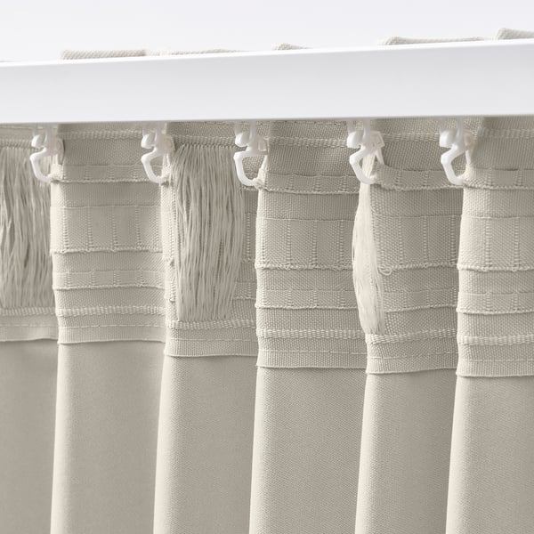Curtain pair with loop hooks, blocking light, featuring textured beige fabric for stylish window coverage.