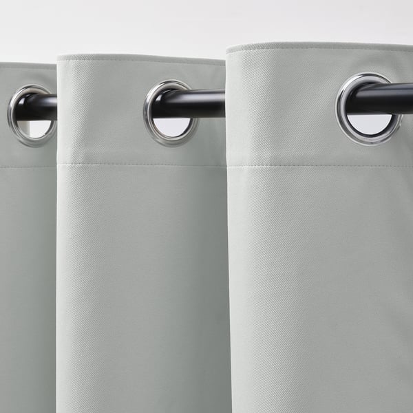 Light-blocking curtains with eyelet holes, designed for easy hanging and smooth operation.