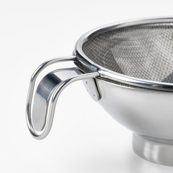 Stainless steel kitchen strainer with sturdy, ergonomic handle for safe and efficient food straining.