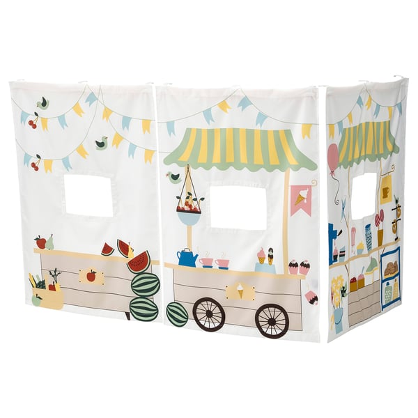 Depicts KURA bed curtains with a playful market stall design in white, featuring watermelons, ice cream, and vibrant decorations.