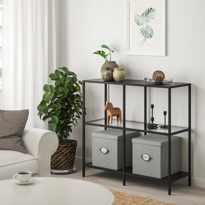 White KVARNVIK storage box with gray pattern on shelf, lined fabric, and plant.