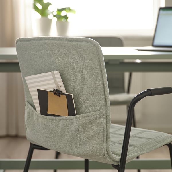 Chair with pocket, holding notebook and paper. Suitable for conference rooms.