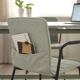 Chair with pocket, holding notebook and paper. Suitable for conference rooms.