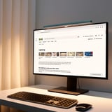 Office desk with monitor, keyboard, mouse, and LAGERGÅNG lamp.