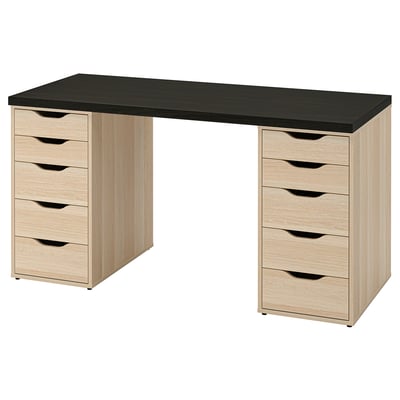 An ikea LAGKAPTEN desk in black and oak, rectangular with two storage units on either side, each having multiple drawers.