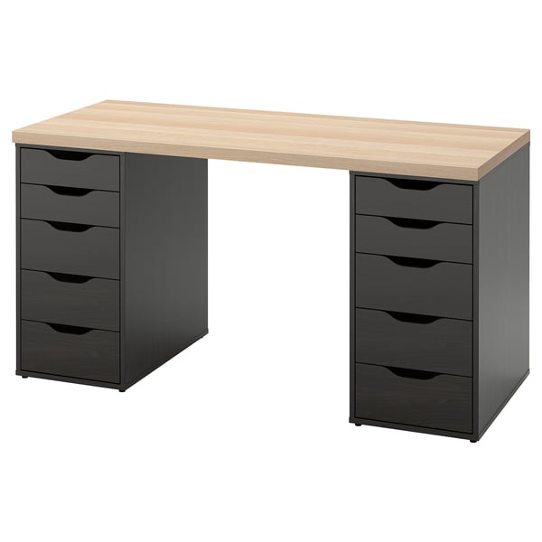 An ikea LAGKAPTEN desk in light oak and black with five drawers per side.