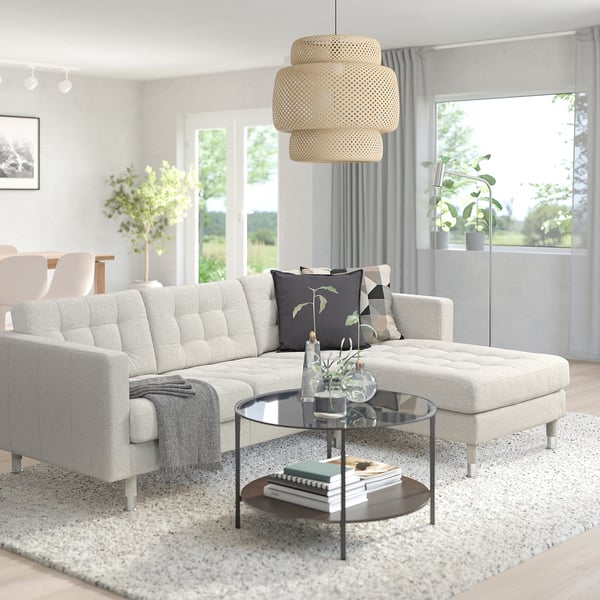 Modern living room with a large grey LANDSKRONA sectional sofa, soft cushions, a glass coffee table, hanging wicker lamp, and large windows.
