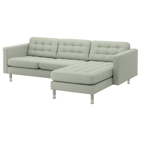 Modern light gray l-shaped sofa with tufted back and seat cushions, chrome legs, neat and stylish.