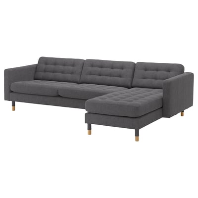 Modern gray l-shaped sectional sofa with tufted cushions, dark wood legs, and sleek design.