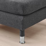 Dark gray fabric footstool with chrome legs on wooden floor.