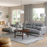Modern living room with LÅNGARYD gray sofa, large & cozy, wood coffee table, stylish decor, big window with curtains.
