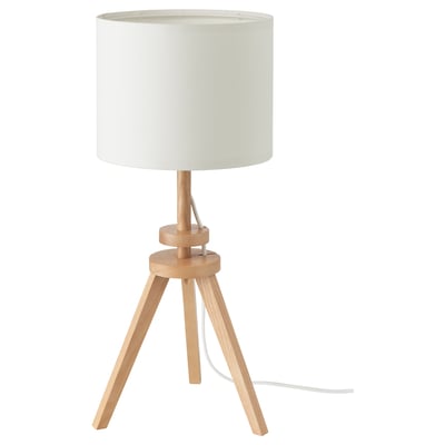 A LAUTERS lamp with light wood color, round shade, and tripod base design. Made from recycled materials and solid wood.