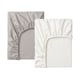 Two fitted sheets shown, one white, one gray. Made of lyocell and cotton. Elastic edges for security.