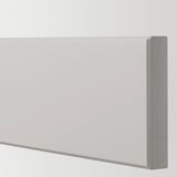 Close-up of sleek, grey kitchen cabinet with smooth, bevelled edges.
