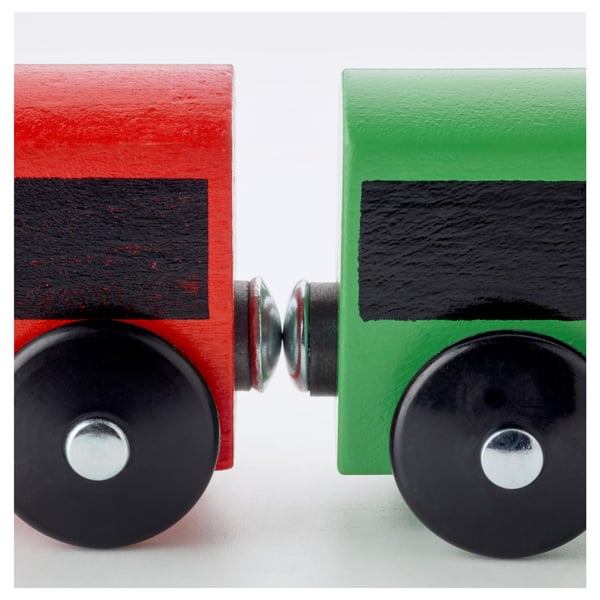 Two vibrant wooden toy train cars, red and green, linked by a metal connector, showcasing durable construction and vivid colors.