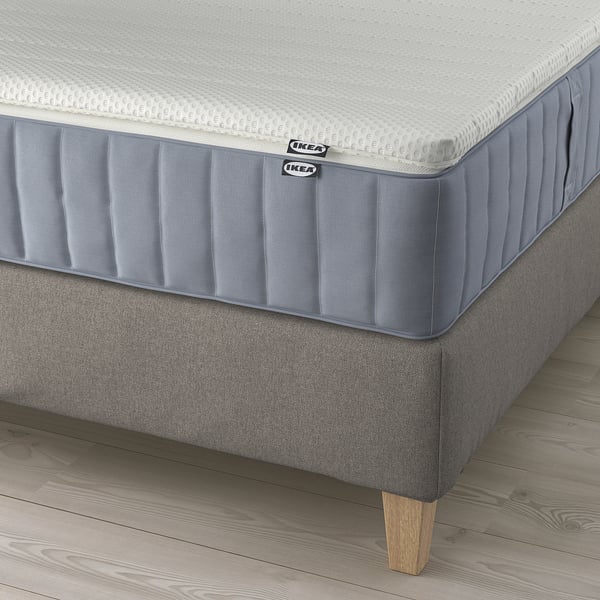 IKEA lilfjallet divan bed: grey upholstered bed frame with wooden legs, two mattresses displayed, featuring removable, machine-washable covers.