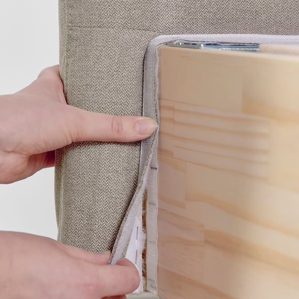 Hand opening fabric divider on lilfjallet bed, showing storage space.