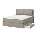 Modern grey upholstered bed with sloped headboard, cushions, and storage drawers. Efficient and stylish design for comfort and space.